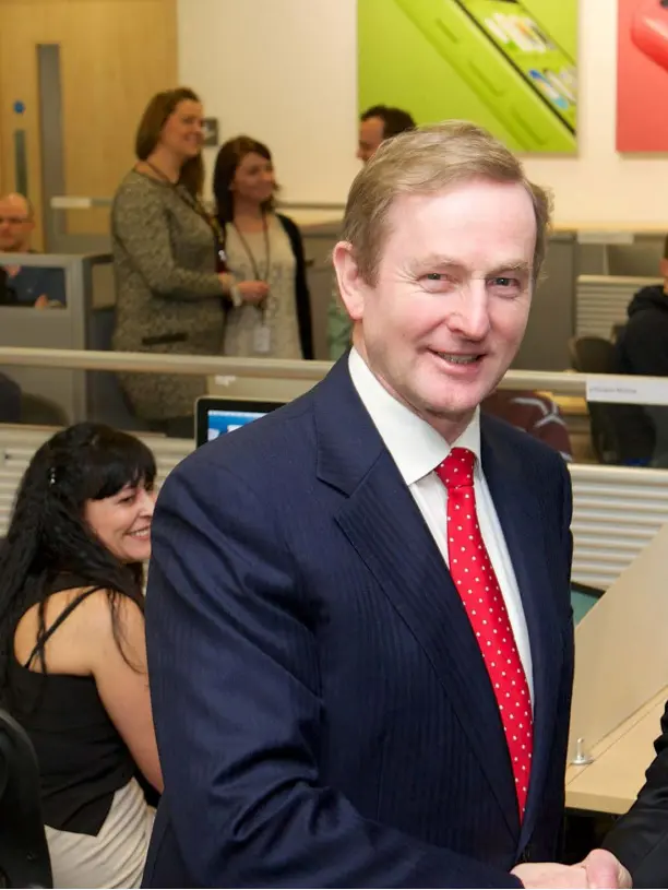  ??  ?? Taoiseach Enda Kenny and Apple CEO Tim Cook on a visit to Apple’s Cork facility in 2014. Back in October 1980, Apple opened their factory in Hollyhill with just