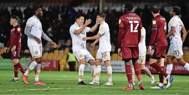  ?? Nathan Stirk ?? ●● Ellis Jones and George Lloyd celebrate after Max Taylor’s own goal during the Papa John’s EFL Trophy. See page 42 and 43