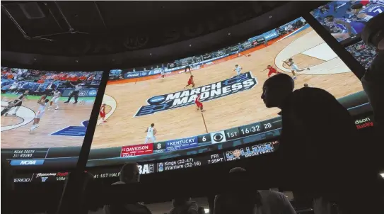  ?? AP FILE PHOTO ?? MADNESS: People wait in line to bet on the NCAA college basketball tournament at the Westgate Superbook sports book in Las Vegas earlier this year.