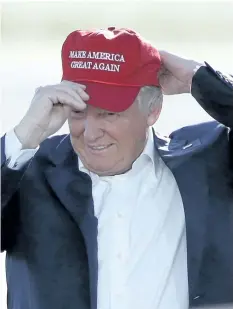  ?? THE ASSOCIATED PRESS FILES ?? In this June 1, 2016, photo, then Republican presidenti­al candidate Donald Trump wears his “Make America Great Again” hat at a rally in Sacramento, Calif. An Ontario judge who wore a hat in court bearing a slogan used by Trump was suspended without pay...