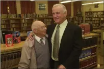  ?? NEWS-HERALD FILE NEWS-HERALD FILE ?? Don Shula talks with Harvey football players Adam Bolinger, left, and Tyler Shaffer during a visit back to his alma mater in October 2004.
Don Shula shares an embrace with longtime football coach and equipment manager Tony Cimaglio during a visit to Harvey in 2004.