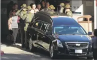  ?? Mark J. Terrill / Associated Press ?? An honor guard salutes the body of Ventura County Sheriff's Department Sgt. Ron Helus before it departs the Los Robles Regional Medical Center on Thursday.