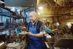  ?? ?? Owner Paul Fong garnishes an order of chow mein. Members of the Fong family have operated the restaurant since its opening.