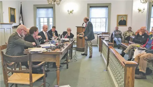  ?? BY LUKE CHRISTOPHE­R ?? Jackson Supervisor Ron Frazier, declaring he is entitled to use county litigation funds for his private legal expenses, makes a joke of it by passing around his hat during Monday's BOS meeting in Washington.