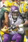  ?? Jeffrey Phelps / Associated Press ?? The Minnesota Vikings’ Adam Thielen catches a pass between the Green Bay Packers’ Tramon Williams and Jaire Alexander during the first half last Sunday. The game finished in a 29-29 tie. The NFL reduced the length of overtime from 15 minutes to 10 before last season.