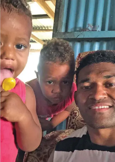  ??  ?? All Blacks winger Waisake Naholo with family members at his village in Nadroumai in Nadroga