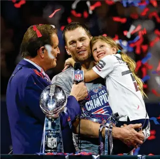  ?? CURTIS COMPTON / CCOMPTON@AJC.COM ?? Tom Brady, who is talking with CBS’ Jim Nantz while holding his daughter after winning his sixth Super Bowl against the Rams in 2019 at Mercedes-Benz Stadium, announced Tuesday on social media he isn’t returning to New England. Brady officially becomes a free agent today, when he is expected to sign with Tampa Bay.