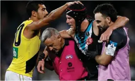  ??  ?? Marlion Pickett of Richmond Tigers acknowledg­es Port Adelaide Power’s Brad Ebert as Ebert is taken from the ground after suffering a concussion in Adelaide in October. Photograph: Ryan Pierse/Getty Images