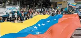  ?? FEDERICO PARRA/GETTY-AFP ?? People gather in Caracas on Sunday to cast votes on rewriting the nation’s constituti­on.