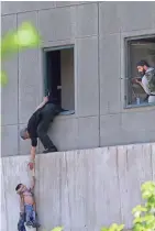  ?? ASSOCIATED PRESS ?? A man hands a child to a guard in Iran's parliament building after a terror attack.