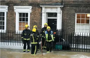  ??  ?? Above: the flooding caused by a burst mains pipe on London’s Upper Street. Right: Cressida at home today