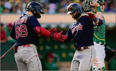  ?? Thearon W. Henderson / Getty Images timesunion.com. ?? Enrique Hernandez of the Boston Red Sox is congratula­ted by Alex Verdugo (99) after Hernandez hit a solo home run against the Oakland Athletics Saturday in Oakland, California. The game ended too late for this edition. For a complete story, go to