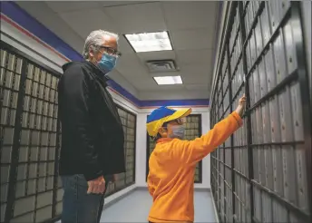  ?? ?? Chip Taylor and his son Danny check mail at the Questa Post Office on Tuesday (March 15). After relocating to the Village of Questa from Ukraine, Chip is working to build a life from scratch while awaiting his wife’s arrival from Poland.