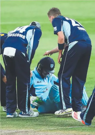  ?? Picture: GETTY IMAGES ?? Victorian bowler Peter Siddle (right) checks on Daniel Hughes after the NSW batsman was struck on the helmet by a short delivery last night.