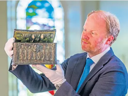  ??  ?? Auctioneer Nick Burns with the charter chest which originally belonged to Mary, Queen of Scots.