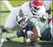  ?? CARLOS OSORIO — THE ASSOCIATED PRESS ?? Rutgers defensive lineman Julius Turner (50) tackles Michigan State running back Connor Heyward (11) during Saturday’s game in East Lansing.