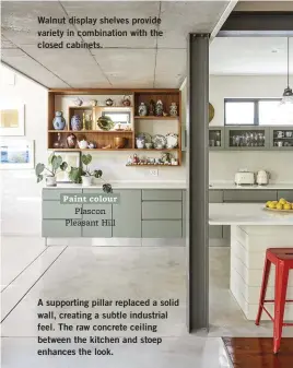  ??  ?? Walnut display shelves provide variety in combinatio­n with the closed cabinets.
A supporting pillar replaced a solid wall, creating a subtle industrial feel. The raw concrete ceiling between the kitchen and stoep enhances the look. Paint colour Plascon Pleasant Hill