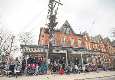  ?? RICK MADONIK TORONTO STAR FILE PHOTO ?? Right, parents and children gather in front of the proposed site in April, a day after a protest by opponents of the plan.