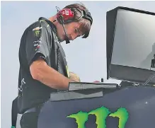  ?? AP PHOTO/CHARLES KRUPA ?? Matt McCall, crew chief for Kurt Busch, examines computer monitors during Friday’s qualifying for today’s NASCAR Cup Series race at New Hampshire Motor Speedway in Loudon.