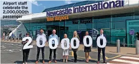  ?? ?? Airport staff celebrate the 2,000,000th passenger