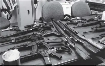  ?? AP ?? These weapons were found in the Prince George’s County, Md., residence of a man identified in a search warrant as Neil E. Prescott after he allegedly made a threat.