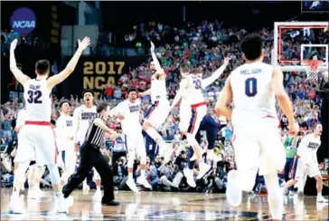  ?? TOM PENNINGTON/GETTY IMAGES/AFP ?? The Gonzaga Bulldogs celebrate after defeating the South Carolina Gamecocks in the 2017 NCAA Final Four at the University of Phoenix Stadium on Saturday.