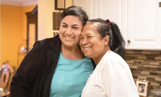  ?? ASHLEE REZIN GARCIA/SUN-TIMES FILE ?? Karla Taylor-Bauman hugs her mother, Irma Escalante. After the ordeal she’s gone through over the past year with COVID-19 and the threat of losing her home, TaylorBaum­an has plenty to be happy about now.