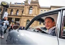  ?? AP PHOTO/MICHAEL PROBST ?? Porsche CEO Oliver Blume sits in an old Porsche 356 on Thursday at the start of Porsche’s market listing at the stock market in Frankfurt, Germany.