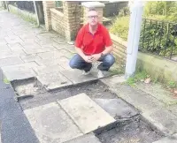  ??  ?? Coun Eamonn Higgins with holes left by stolen flags taken on Avenue Parade and other losses on Spencer Street (left) and Foster Street