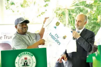  ??  ?? Rivers State Governor, Nyesom Ezenwo Wike (left) receiving a jersey from Real Madrid Ambassador, Ricardo Gallego during the foundation stone laying ceremony of the Real Madrid Football Academy in Port Harcourt… yesterday.