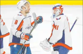  ?? Jeffrey T. Barnes The Associated Press ?? Washington’s Alex Ovechkin and goaltender Vitek Vanecek get ready to exchange glove taps after their 6-0 victory Monday night over the Buffalo Sabres.