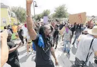  ?? STEPHEN M. DOWELL/ORLANDO SENTINEL ?? Miles Mulrain, center, founder of nonprofit Let Your Voice Be Heard and one of the most visible leaders of Central Florida protests against brutality, said OCSO’s refusal to release bodycam footage of a shooting is part of a pattern of painting those injured or killed by police as guilty.