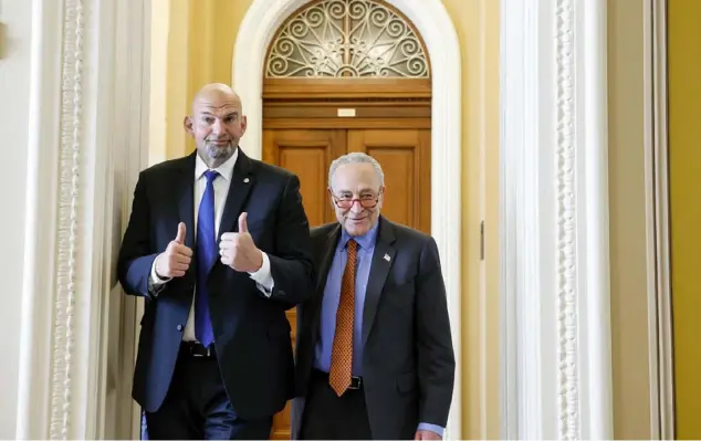  ?? Anna Moneymaker/Getty Images ?? Sen. John Fetterman, D-Pa., with Senate Majority Leader Chuck Schumer, D-N.Y., gives thumbs up to reporters at the U.S. Capitol Building in April 2023.