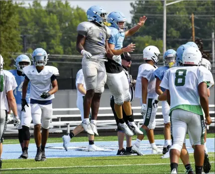  ?? PAUL DICICCO — FOR THE NEWS-HERALD ?? South players celebrate during an Aug. 7scrimmage against Aurora.