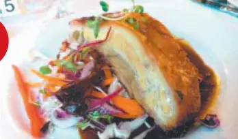  ??  ?? Asian spiced pork belly on a fresh vegetable slaw and hot and sour glaze.