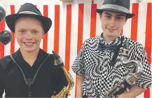  ??  ?? SHOWTIME: Cairns Youth Orchestra saxophonis­ts Ike Martinez and Matthew Nicol dress to impress at a recent CYO concert in the city. BELOW: Chamber Ensemble leader Erin Welser and Isabella Martin lead the orchestra’s strings section.