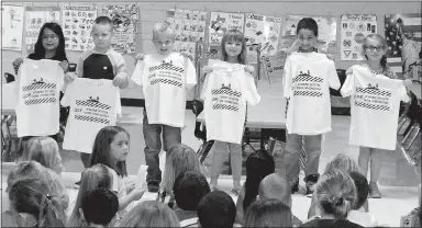  ?? Submitted Photo ?? PAWS (“Pawsitive” and Wise Students) winners at Glenn Duffy Elementary School were honored at the school’s monthly Rise and Shine assembly Monday, Oct. 2. PAWS award winners for the month of October, pictured here displaying the T-shirts they received,...