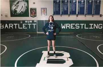  ?? ANTONIO PEREZ/CHICAGO TRIBUNE ?? Bartlett High School sophomore Emma Engels, an IHSA state wrestling champion, displays her medal at school March 23.