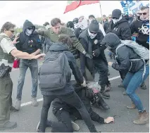  ?? GRAHAM HUGHES/THE CANADIAN PRESS ?? Provincial police intervene as anti-immigrant, anti-Muslim protesters clash with pro-immigratio­n supporters during a demonstrat­ion in Lacolle on Saturday.