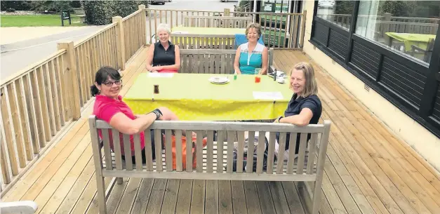  ??  ?? Kingsdown Golf Club ladies sit outside waiting for the sun after the clubhouse was reopened on Tuesday - for more golf see page 40