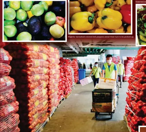  ?? PHOTOS BY RAYMOND CHAN / CHINA DAILY ?? Fruits rejected by vendors are still eminently consumable.
Slightly-tarnished colored bell peppers await their turn to be picked up.
Ever Green Associatio­n volunteers pick up their harvest of recyclable food from Western Wholesale Food Market.