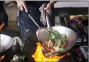  ?? ASSOCIATED PRESS FILE PHOTO ?? A wok is always ideal for making stir fried rice — but isn’t absolutely necessary. A large, non-stick skillet should do just fine.