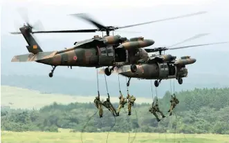  ?? AFPPIX ?? Japanese troops descend from helicopter­s during an annual live-fire exercise at the HigashiFuj­i firing range in Gotemb, at the foot of Mount Fuji last month.