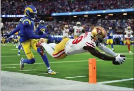  ?? JOSE CARLOS FAJARDO — BAY AREA NEWS GROUP ?? The 49ers' Deebo Samuel dives to score a touchdown in front of Los Angeles Rams' Jalen Ramsey in the second quarter of the NFC championsh­ip game in January.