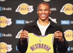  ?? Katelyn Mulcahy / Getty Images ?? Russell Westbrook of the Lakers poses for a picture with his new jersey during a press conference at Staples Center on August 10 in Los Angeles.