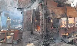  ?? ARVIND YADAV/HT PHOTO ?? Firefighte­rs try to douse a fire at a slum in Gandhi market behind Lok Nayak hospital on Thursday.