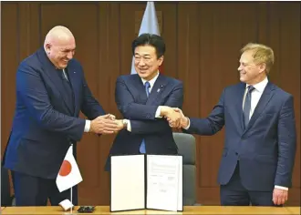  ?? David Mareuil / Pool file photo via AP ?? Britain’s Defense Minister Grant Shapps (right), Italy’s Defense Minister Guido Crosetto (left), and Japanese Defense Minister Minoru Kihara (center), shake hands after a signing ceremony for the Global Combat Air Programme (GCAP) at the defense ministry on Dec. 14, in Tokyo, Japan. Japan’s Cabinet on Tuesday, approved a plan to sell future next-generation fighter jets that it’s developing with Britain and Italy to other countries, in the latest move away from the country’s postwar pacifist principles.