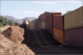  ?? ROSS D. FRANKLIN — THE ASSOCIATED PRESS ?? A long row of double-stacked shipping contrainer­s provide a new wall between the United States and Mexico in the remote section area of San Rafael Valley, Ariz., Thursday, Dec. 8, 2022.