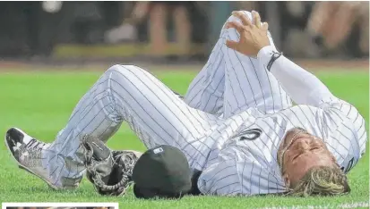  ?? | GETTY IMAGES ( TOP PHOTO), AP ?? Second baseman Yoan Moncada ( above) grabs his right knee after colliding with teammate Willy Garcia ( left) in the sixth inning.