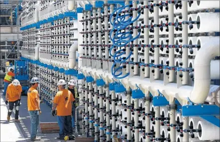  ?? Photog raphs by Don Bartletti
Los Angeles Times ?? THE HEART of Poseidon Water’s desalinati­on plant in Carlsbad is an interconne­cted system of 2,500 reverse osmosis pressure vessels capable of filtering 50 million gallons of seawater a day. The $1-billion plant is expected to be in operation by...